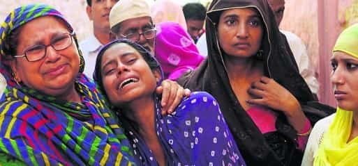 Shaista Akhlaq is comforted by relatives after her 50 year old father Mohammad Akhlaq was beaten to death and her brother was critically injured by a Hindu mob in Bisada village in Greater Noida, India over a false allegation they consumed beef.