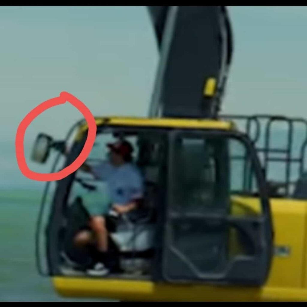 Screenshot of Jeff Wittek's Patreon video shows David Dobrik sitting on the driving seat of the excavator while holding the gears with one hand
