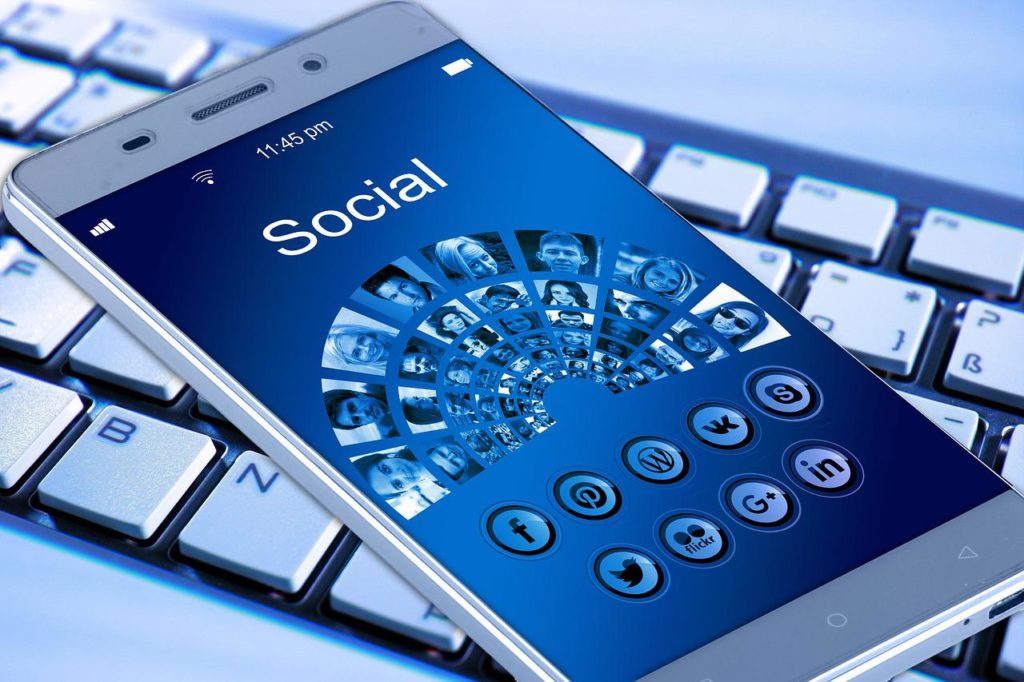 A representative image showing social media platforms and their icons in a mobile phone