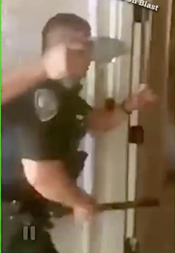 This photo shows Cops breaking into Brandon Calloway's house in Oakland 