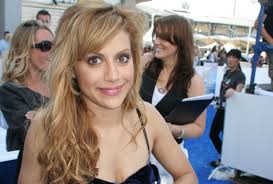 Brittany murphy cause of death. Brittany murphy sitting in a black dress with brown hairs.