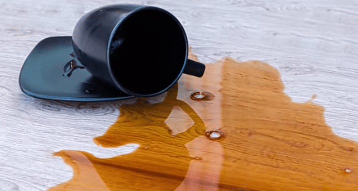 This is photo of cup and liquid on the floor
